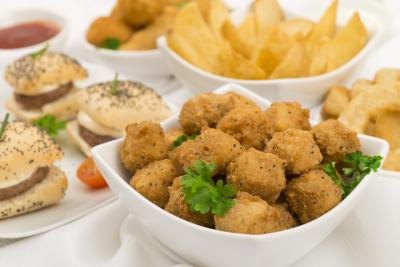 Arrangement of mini burgers, fries, onion rings