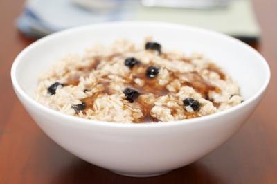 A bowl of oatmeal with maple syrup.