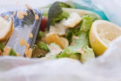A close-up of food waste inside of a garbage bag.