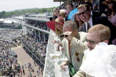 The Crowds and celebrities at Churchill Downs watching the Kentucky Derby race