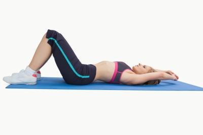 Woman on floor stretching legs.