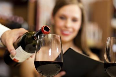 Waiter pouring wine