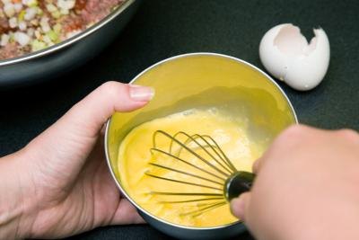 Beat the egg with a whisk.