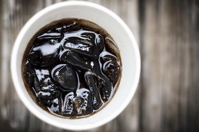 A paper cup with cola.