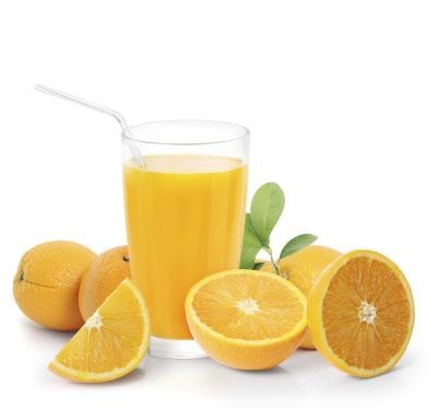 Cup of orange juice surrounded by fresh oranges.