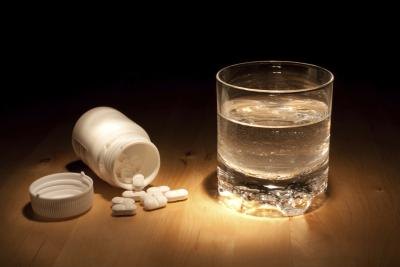 Ibuprofen with a glass of water.