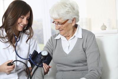 Senior woman gets blood pressure test