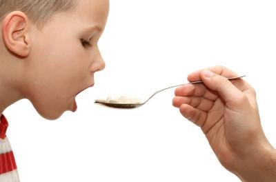 Young boy takes his medicine