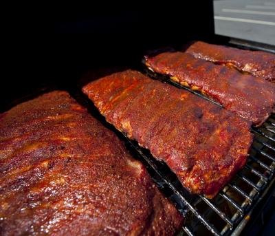 BBQ grill with racks of baby back ribs