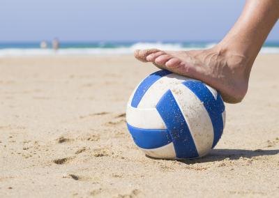 Foot stepping on a ball.