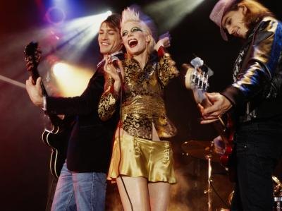 A woman in a rock star costume.