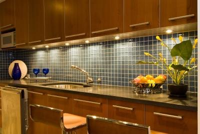 Honey oak cabinets and light gray counters are common structures in both kitchen and bathroom designs.