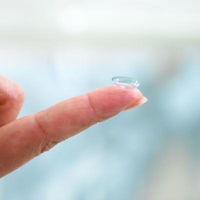Contact lens on fingertip.