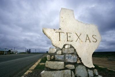 Texas sign, in the shape of the state, at the border
