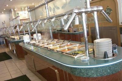 A buffet in a restaurant is ready for patrons.