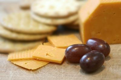 Sliced cheese, crackers and grapes