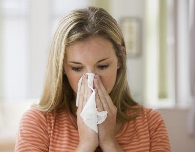 Woman blowing nose