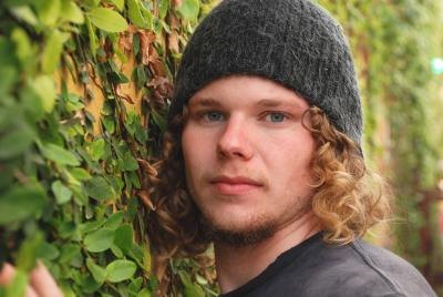 Young man with long curly hair.