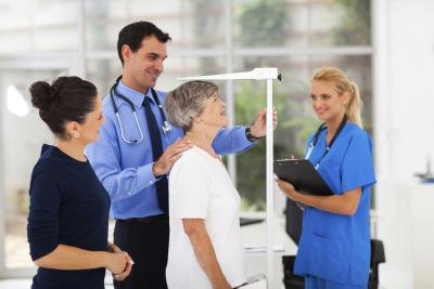 Senior woman gets height measured