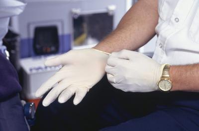 Put on nonsterile plastic gloves before touching or treating the wound.