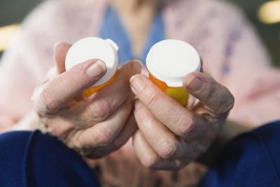 woman holding two bottles of medication