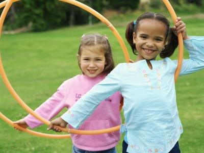2 young girls with hula hoops.