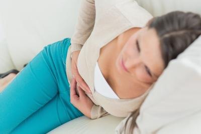 Woman resting on couch after spasm