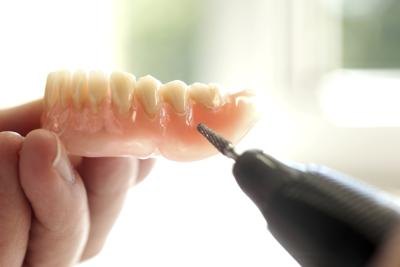 Dentist working on dentures
