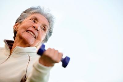 Woman smiling while lifting weights
