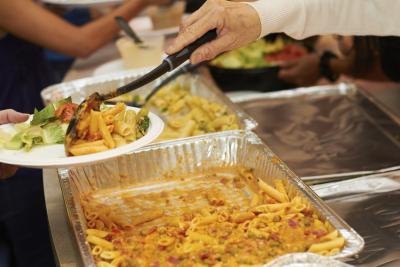 Penne pasta being served at buffet table