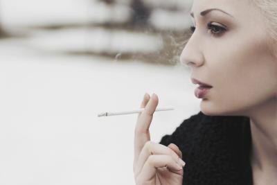 Woman smoking outdoors.