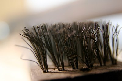 Stiff bristled brushes are for suede, not nubuck.