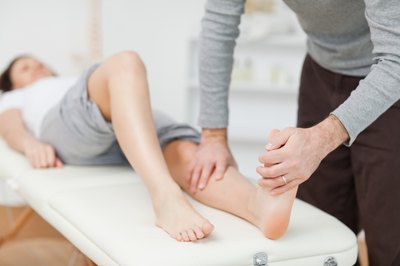 Doctor testing resistance straight of ankle