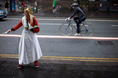 Woman passing out flyers about toga party on college campus