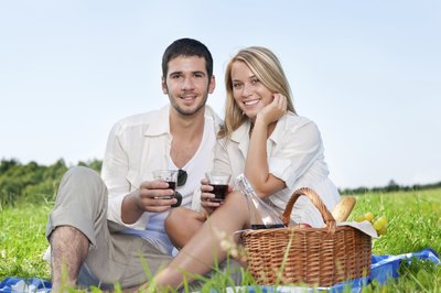 Couple with wine on romantic picnic