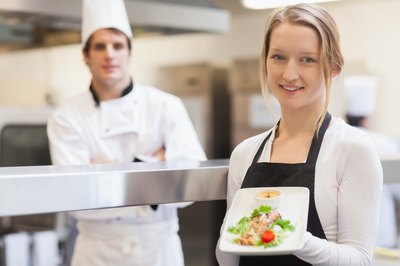 Two teens working in a restaurant.