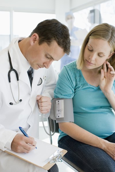 Pregnant woman consulting doctor