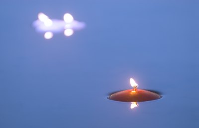 Candles floating on water.
