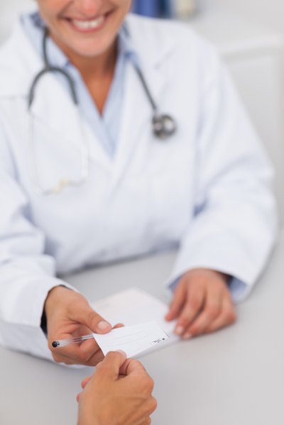 Doctor gives prescription to patient