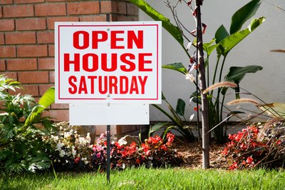 An open house sign in front of a house.