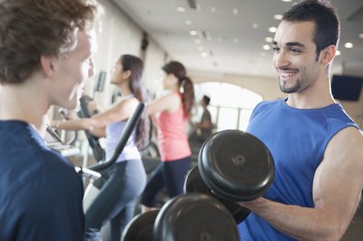 Man lifting weights in gym.