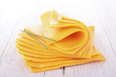 Slices of fresh cheddar cheese