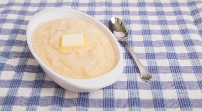 Bowl of grits on checkered table cloth.