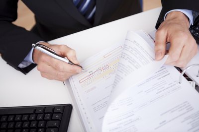 A businessman preparing tax forms at a desk.
