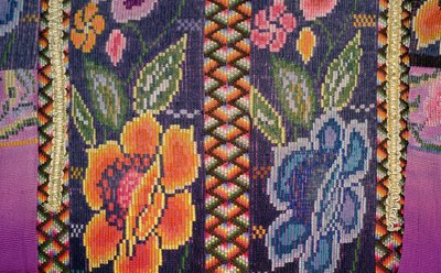 A close-up of embroidered flowers on a shirt.