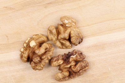 Three walnuts on wood table