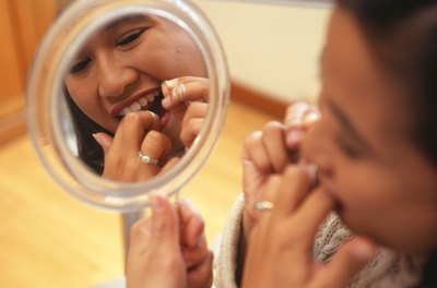 Woman flossing teeth