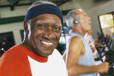 A fit senior using a treadmill at the gym.