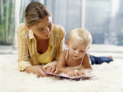 Baby looking at board book