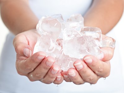 Ice cube in woman's hands